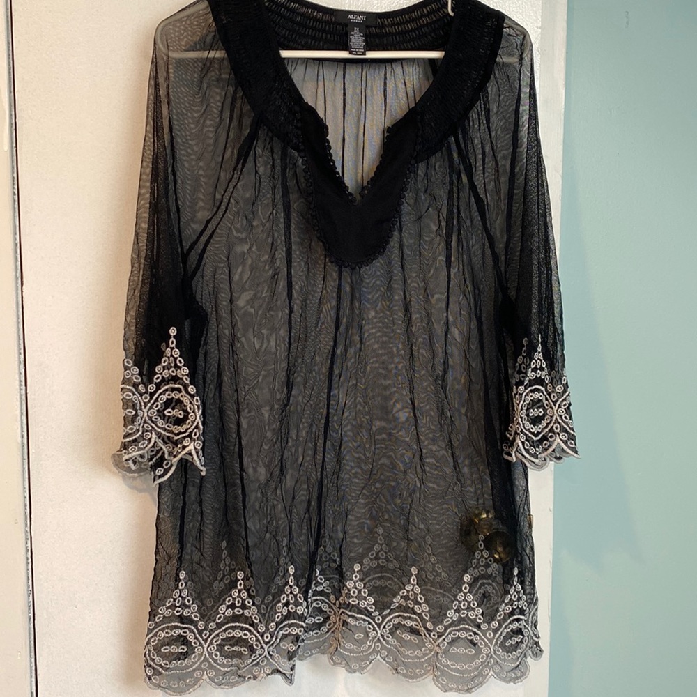 Black sheer mesh top with white stitching.